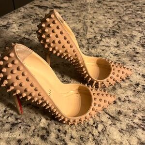 Classy Christian Louboutin nude heels with spikes.